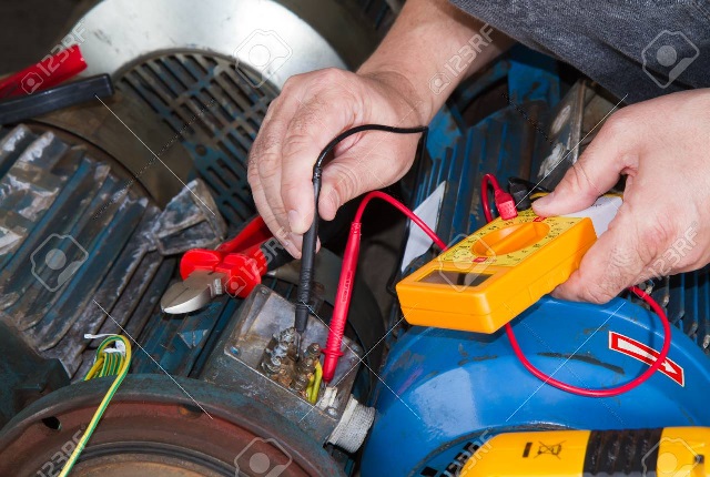 repairman during maintenance work of electric motors